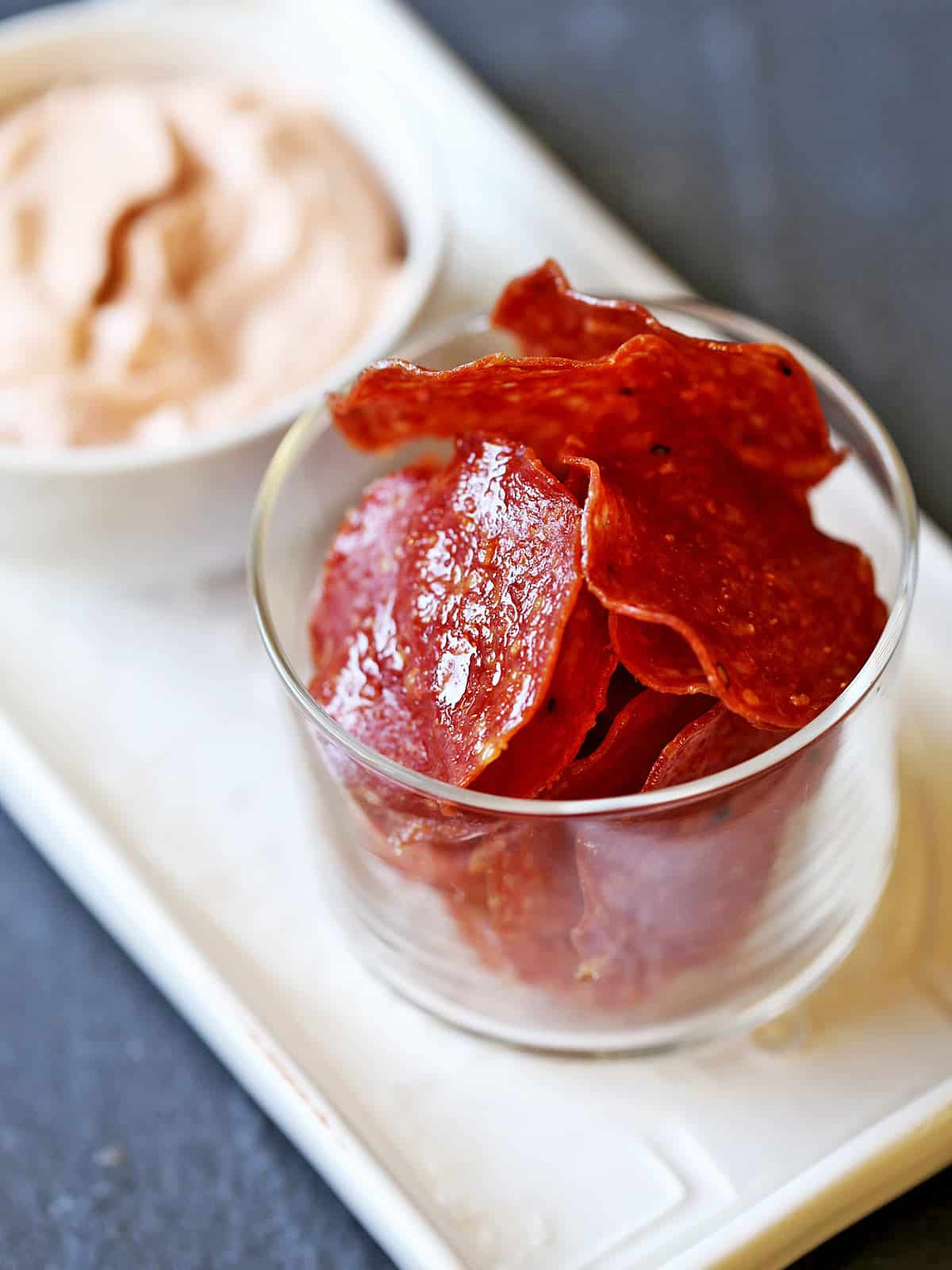 Salami chips served with a spicy dip. 