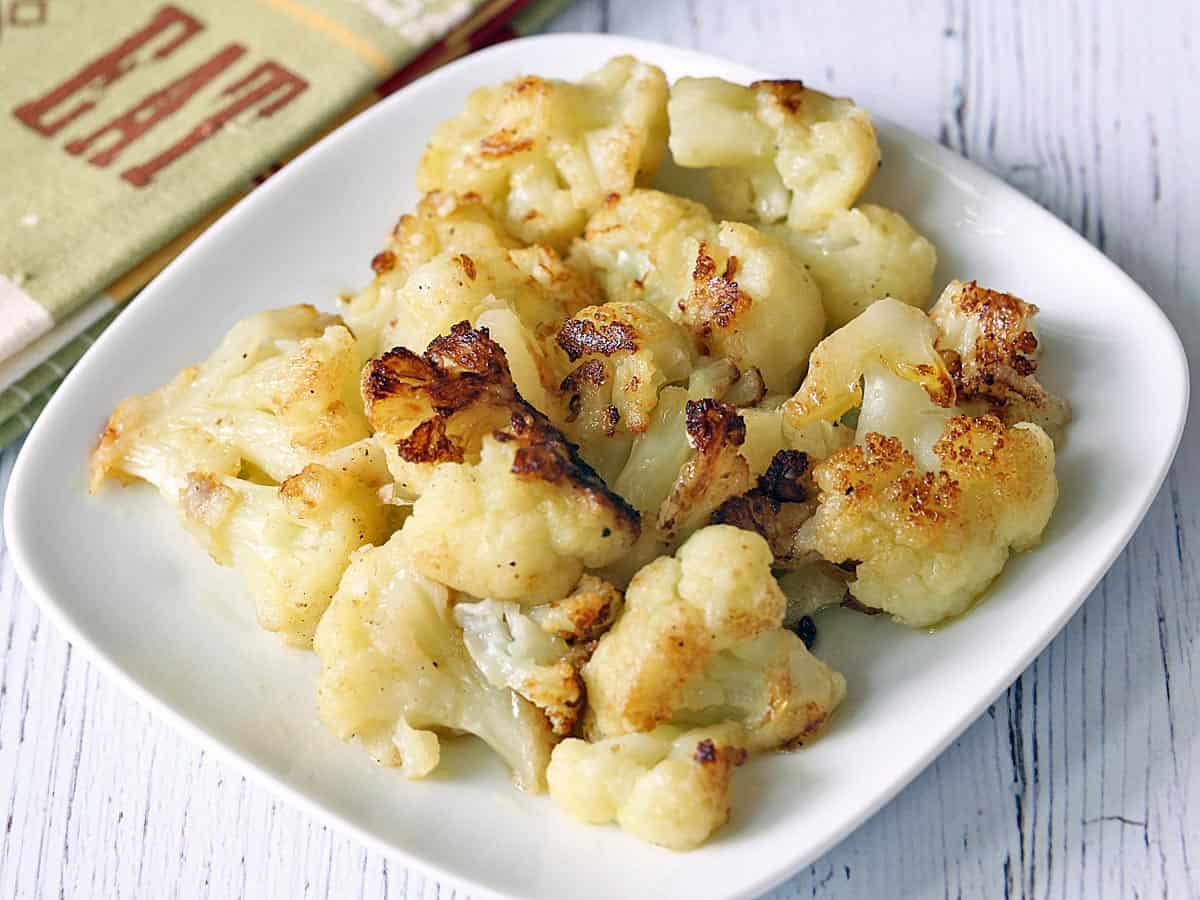 Sauteed cauliflower served on a white plate. 