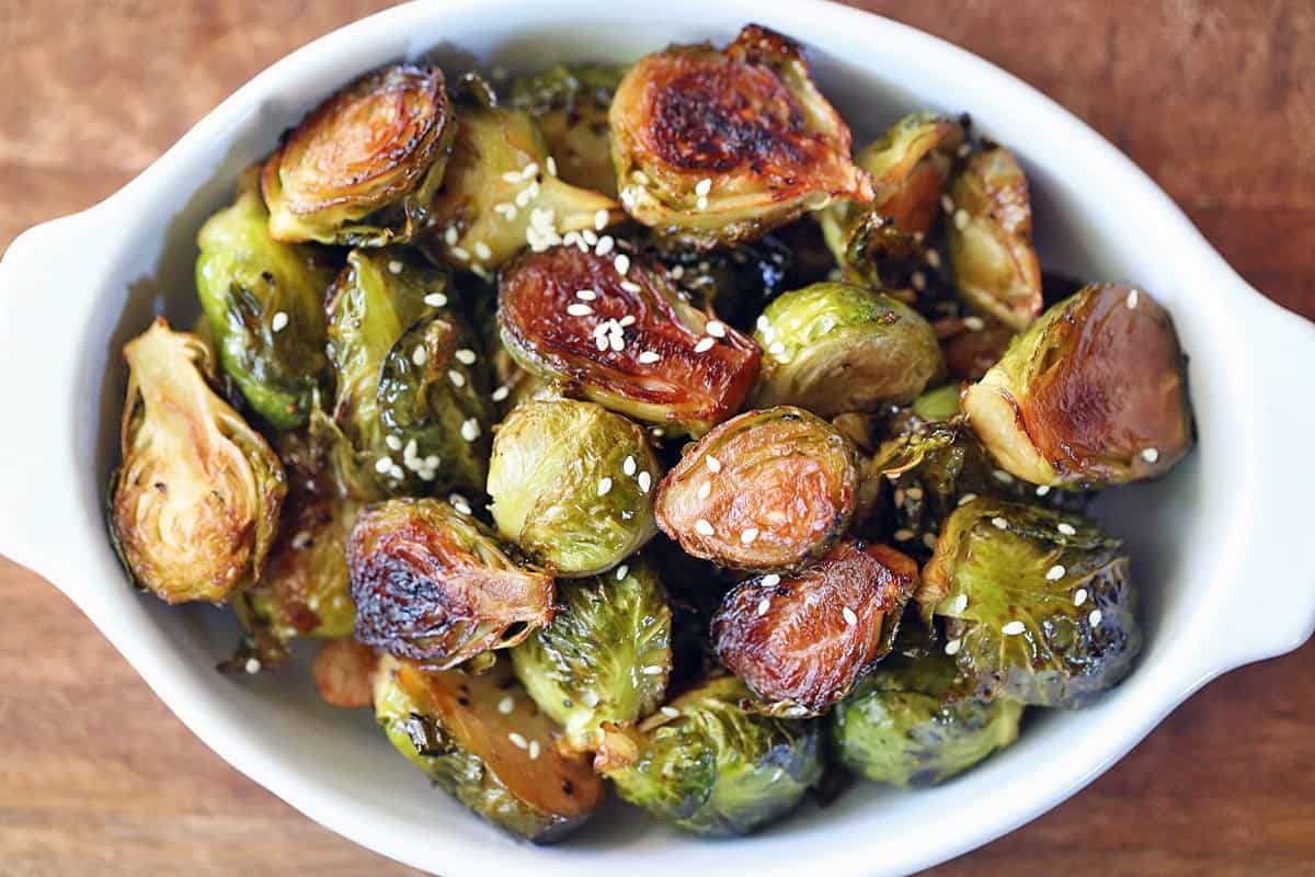 Asian Brussels sprouts served in a white baking dish. 
