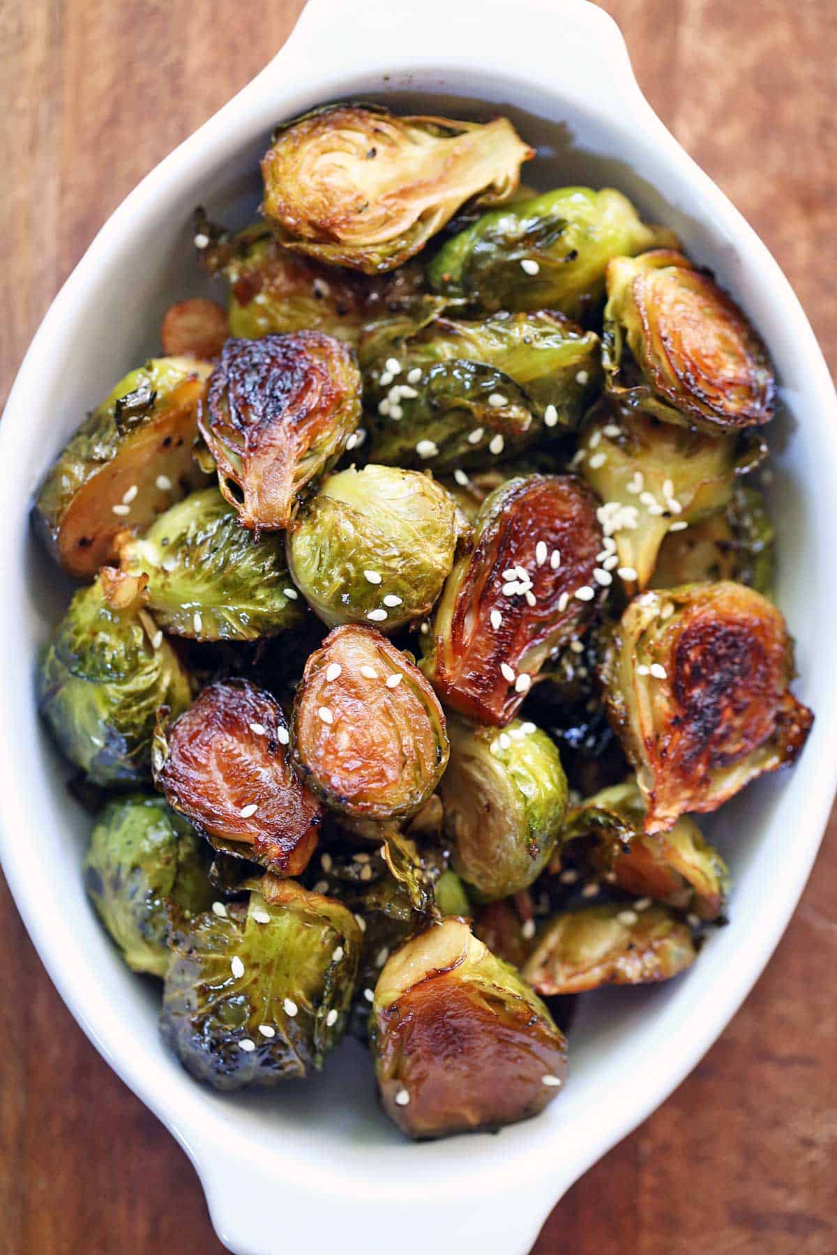 Asian Brussels sprouts served in a white baking dish. 