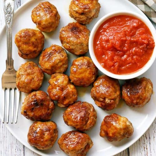 Chicken meatballs served with a dipping sauce.