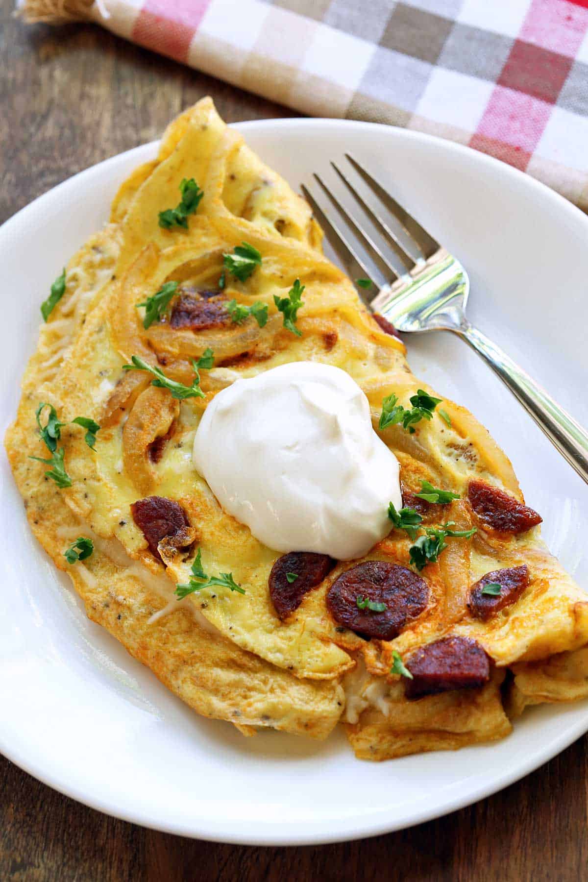 Chorizo omelette topped with sour cream. 