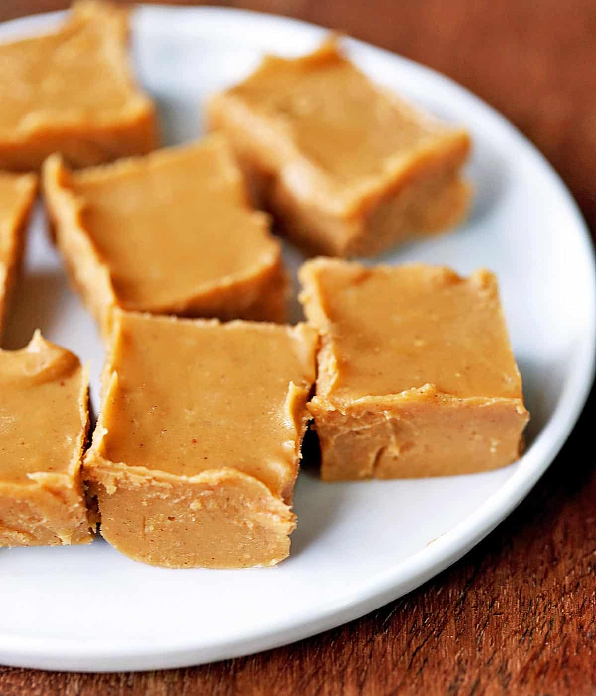 Keto peanut butter fudge squares served on a white plate.