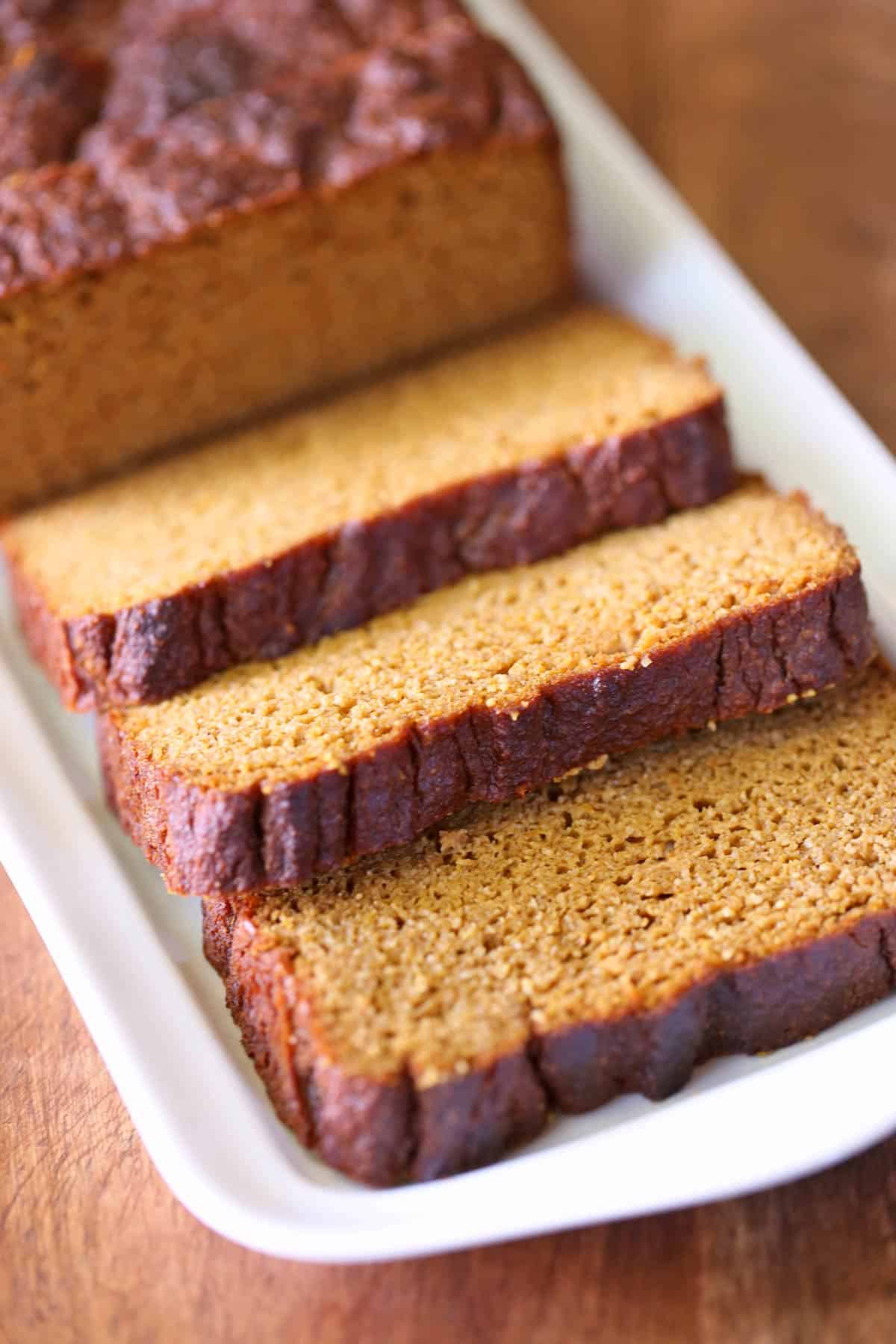 Sliced keto pumpkin bread served on a white tray. 