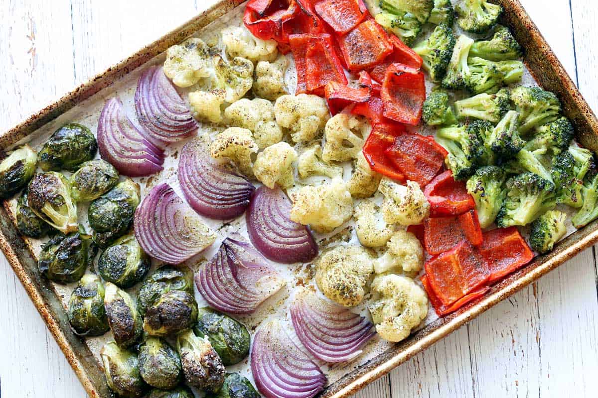 Roasted vegetables arranged in a large baking sheet.