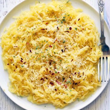 Spaghetti squash noodles served with a fork.