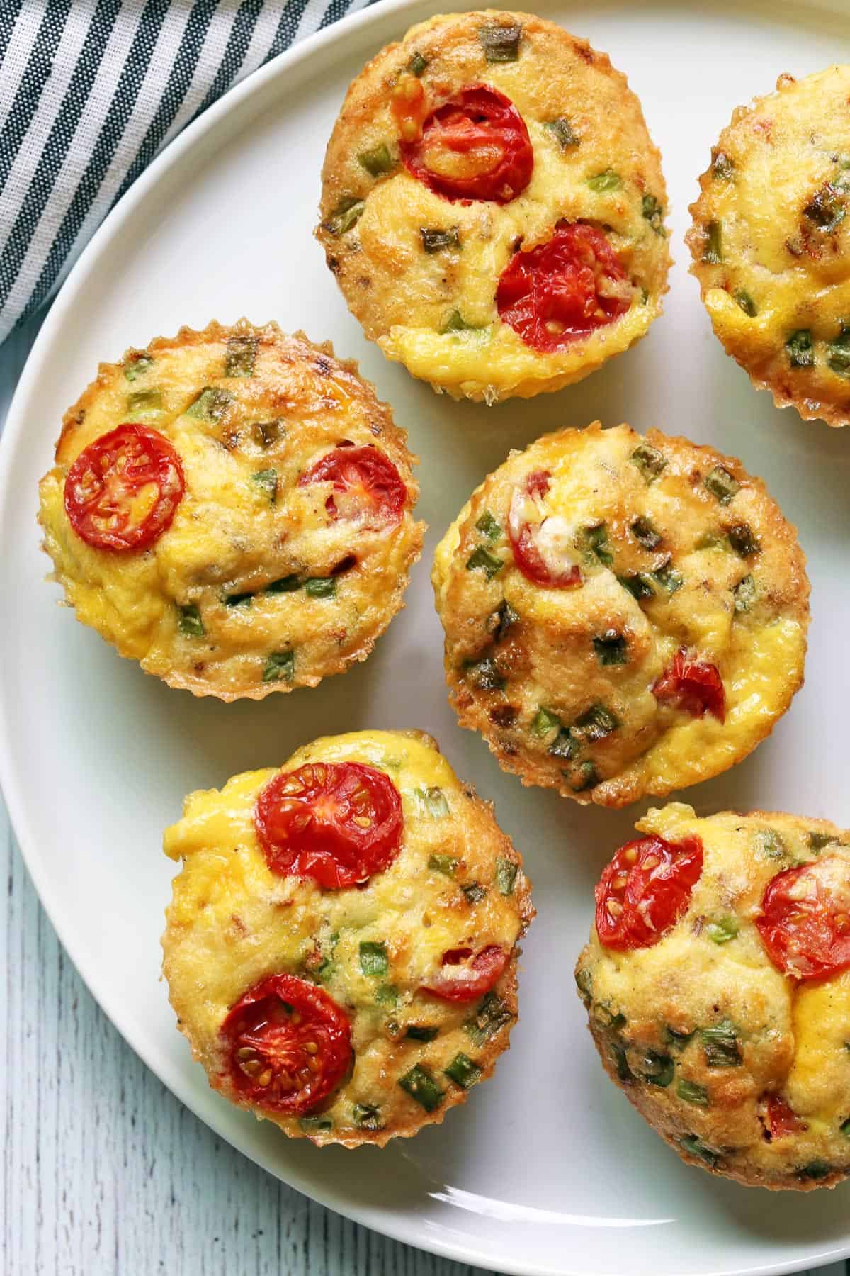 Egg muffins are served on a white plate. 