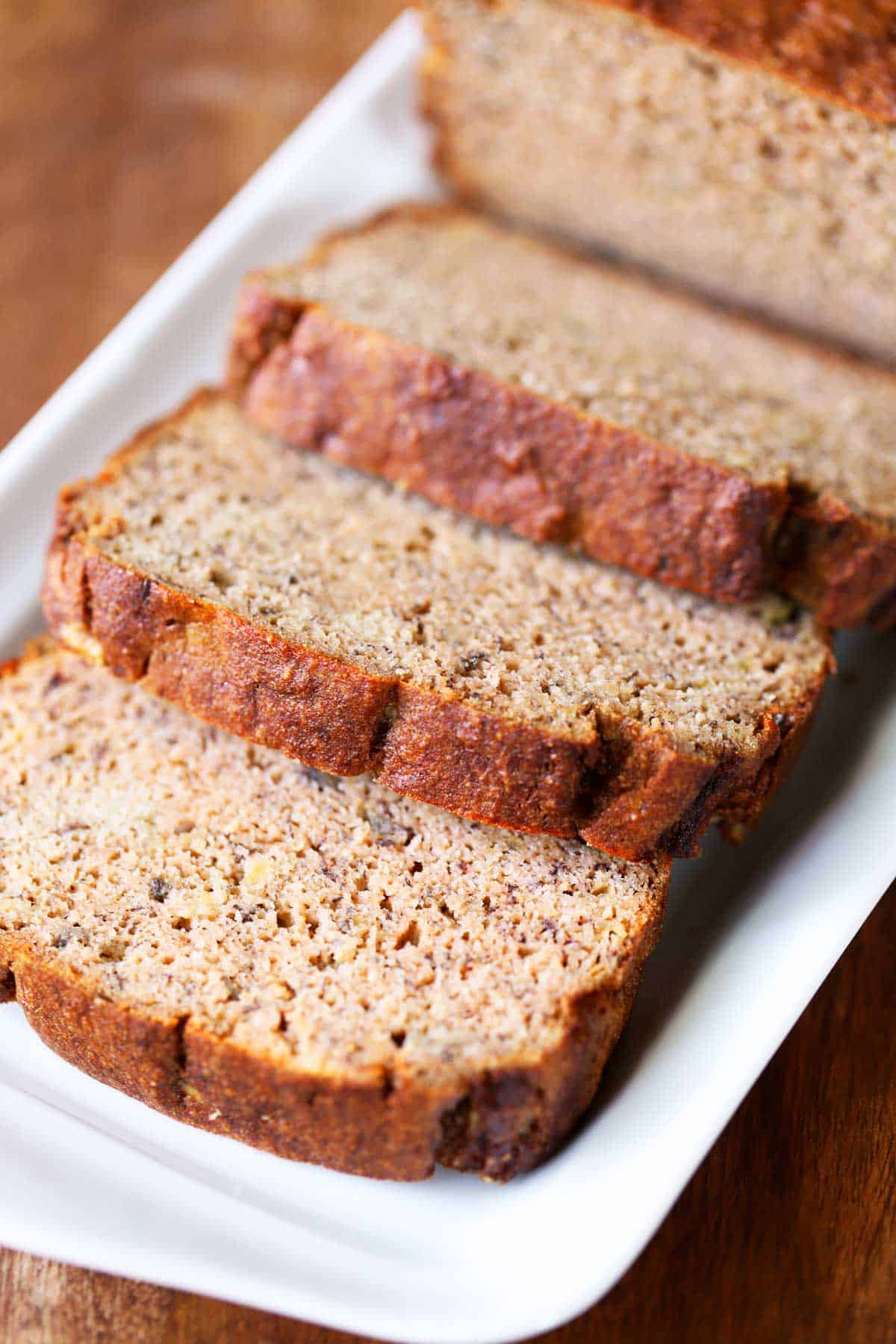 Keto banana bread, sliced, is served on a tray.