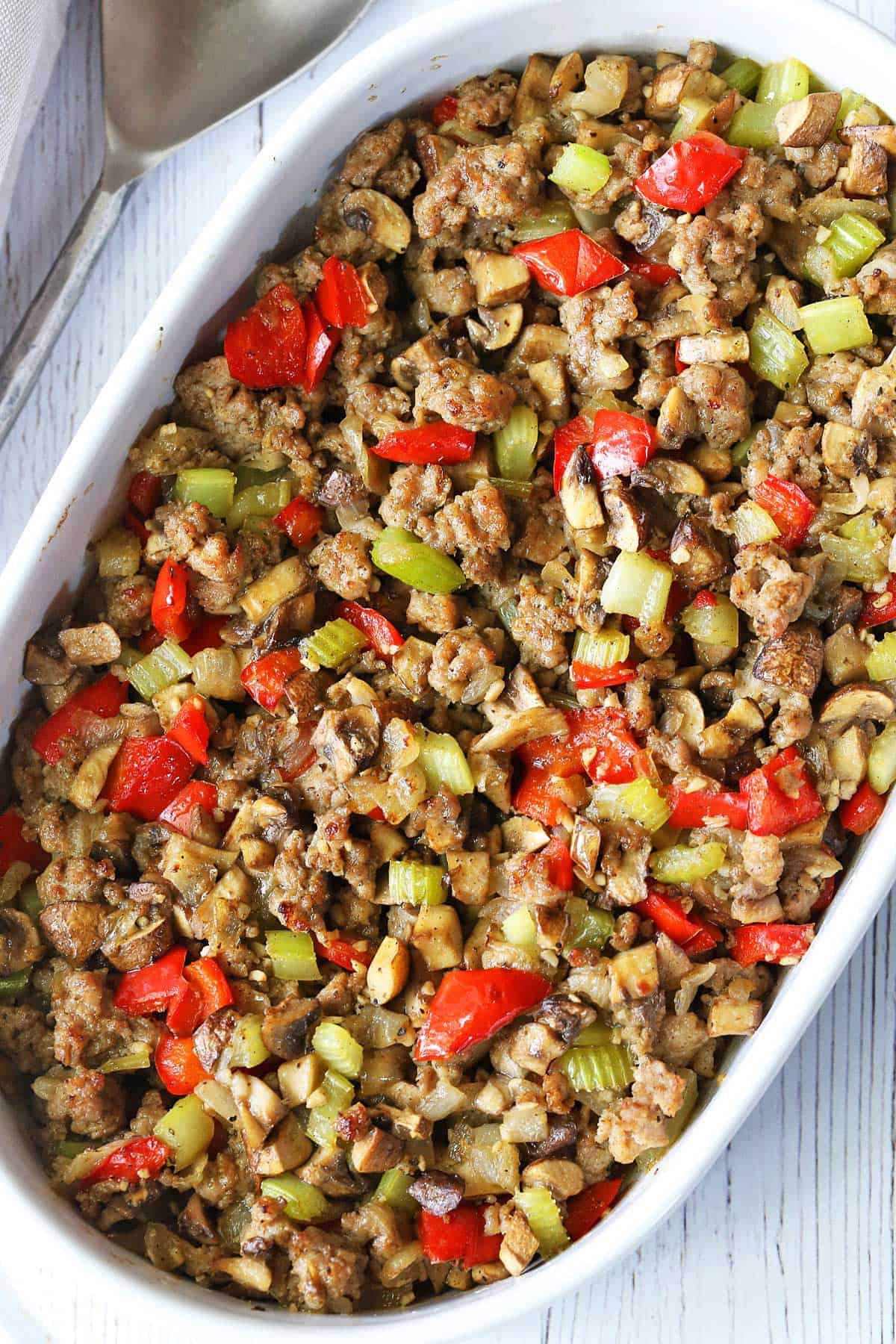 Sausage stuffing is served in a white baking dish. 