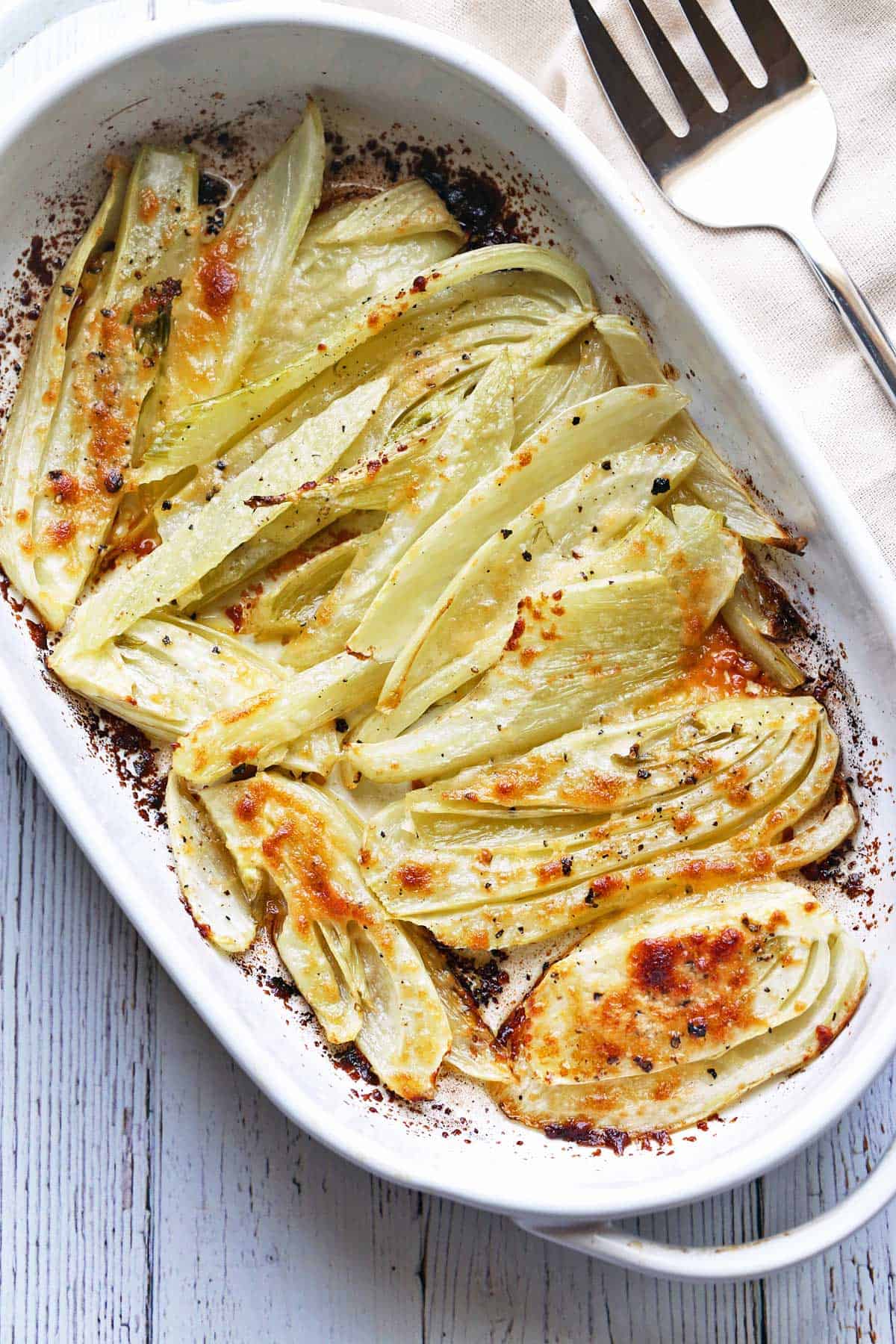 Roasted fennel served in a white baking dish. 