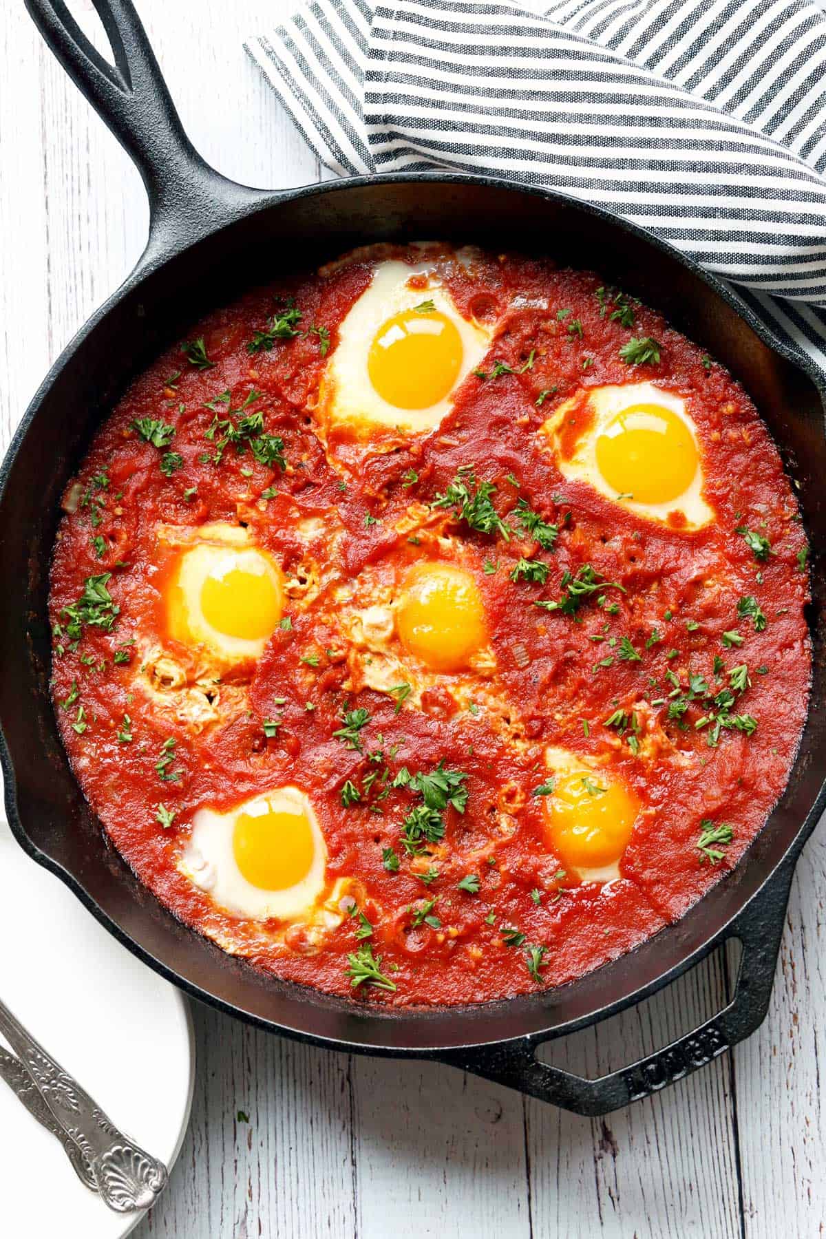 Shakshuka is served in a cast-iron skillet. 