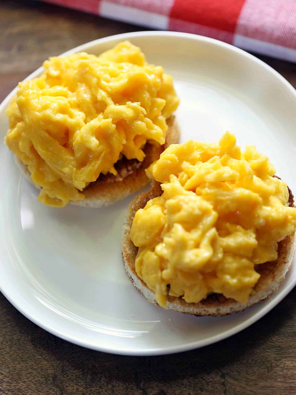 Soft-scrambled eggs served on a white plate. 