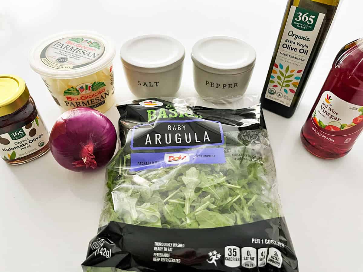 The ingredients needed to prepare an arugula salad. 