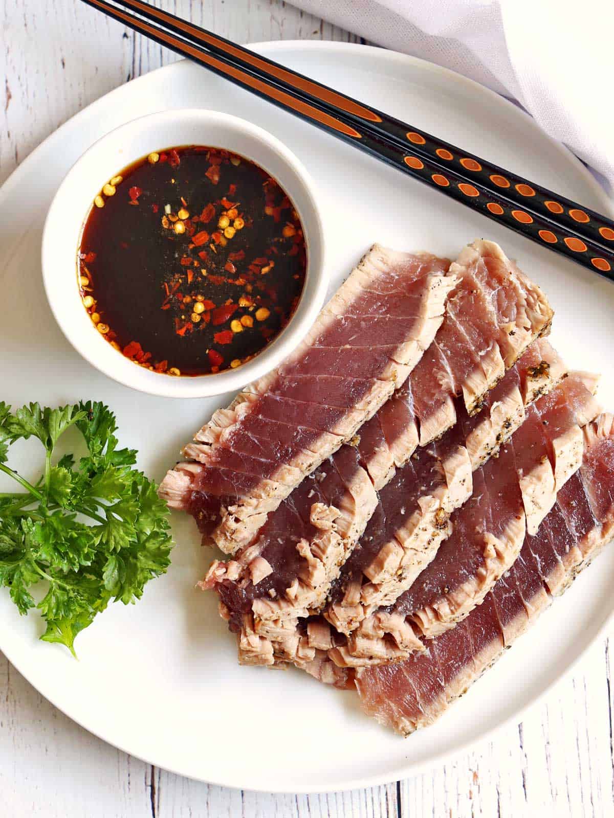 Seared ahi tuna steak served with a dipping sauce. 