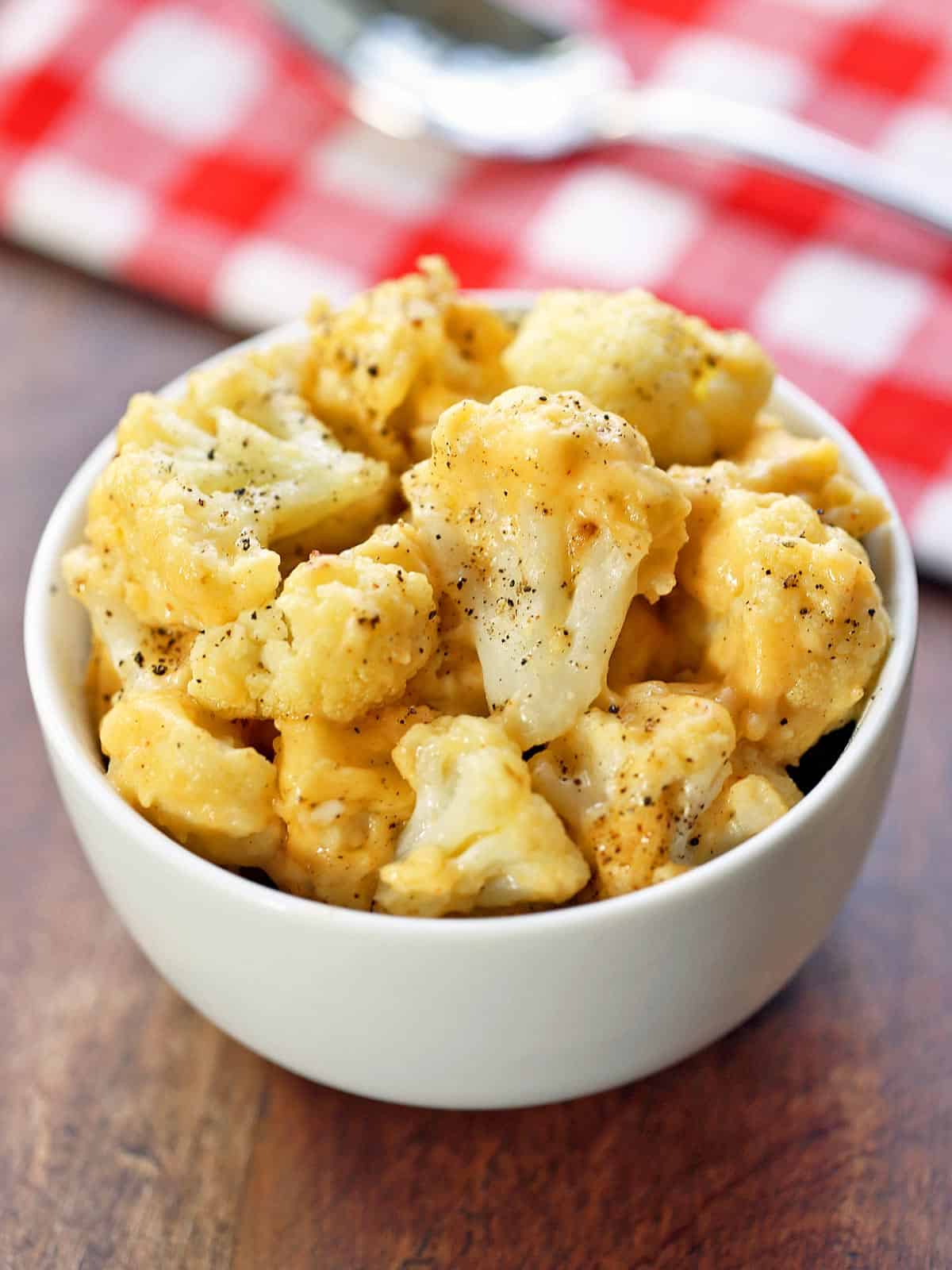 Cauliflower mac and cheese is served in a white bowl. 