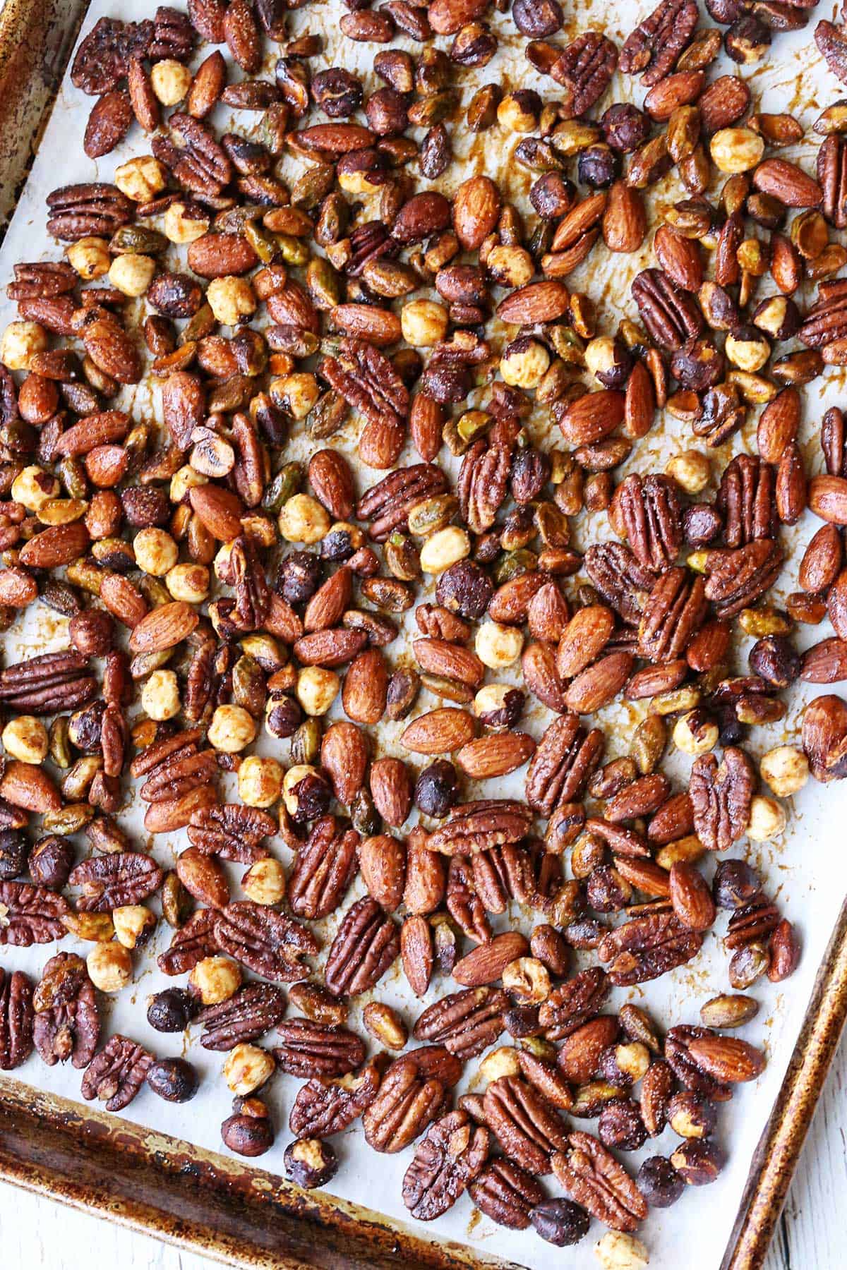Honey-roasted nuts served on a large baking sheet. 
