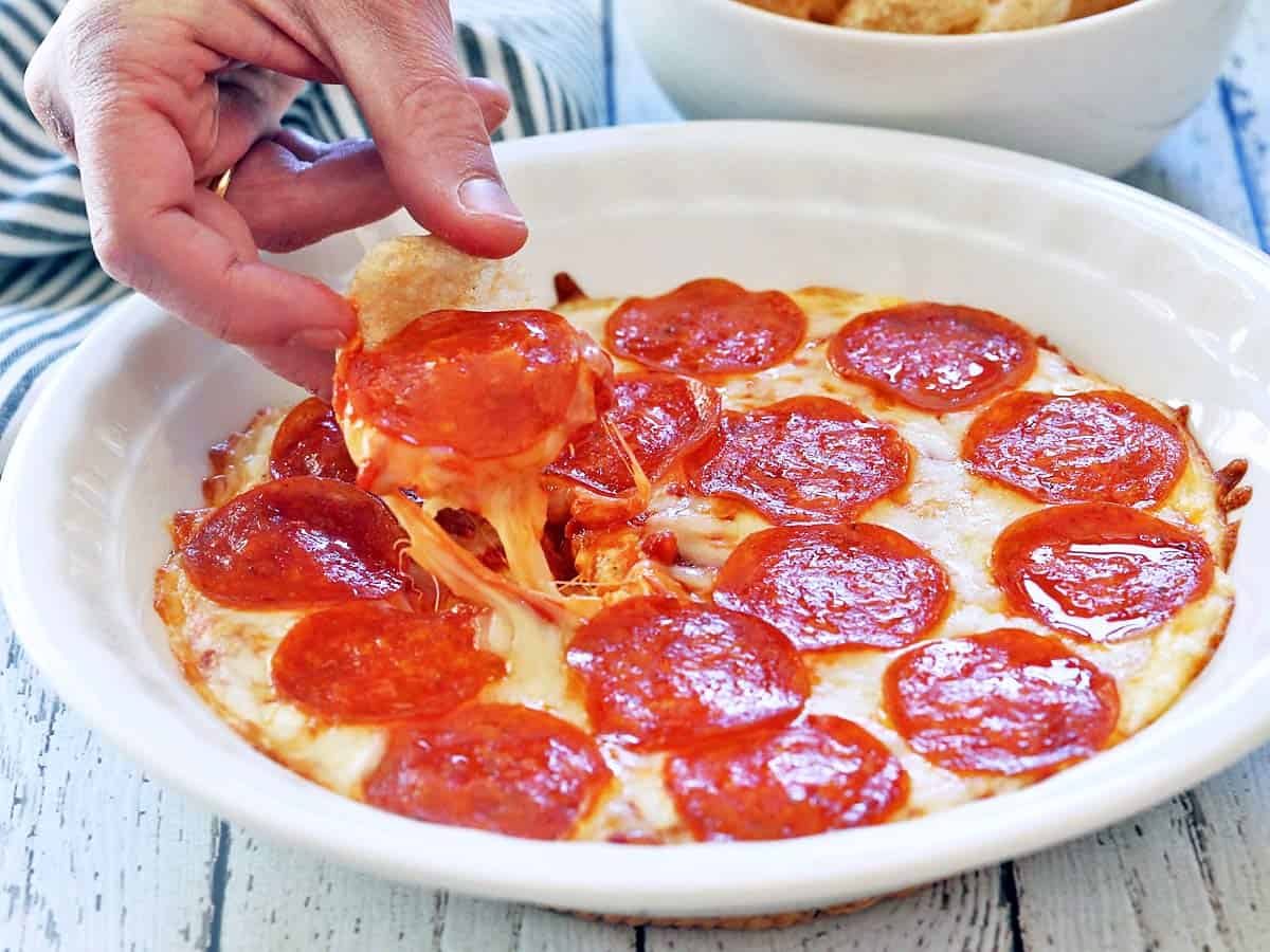 Pizza dip served in a white baking dish. 