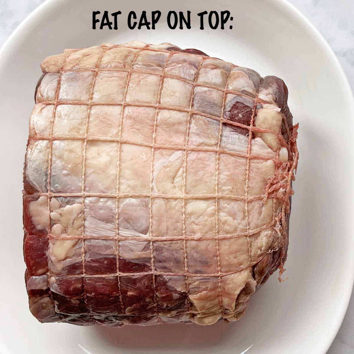 A ribeye roast with its fat cap on top. 