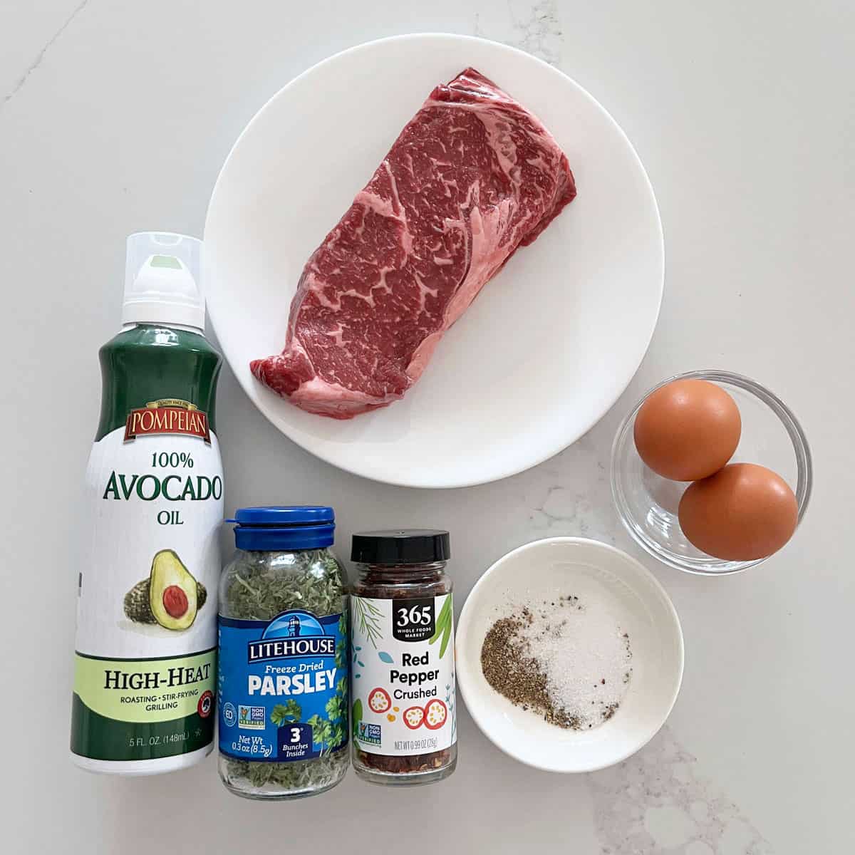The ingredients needed to make a steak and eggs breakfast. 