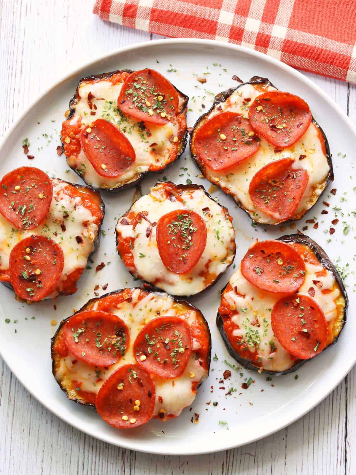 Eggplant pizza served on a white plate. 