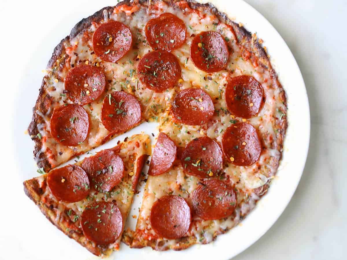 Cauliflower pizza crust topped with cheese and pepperoni. 