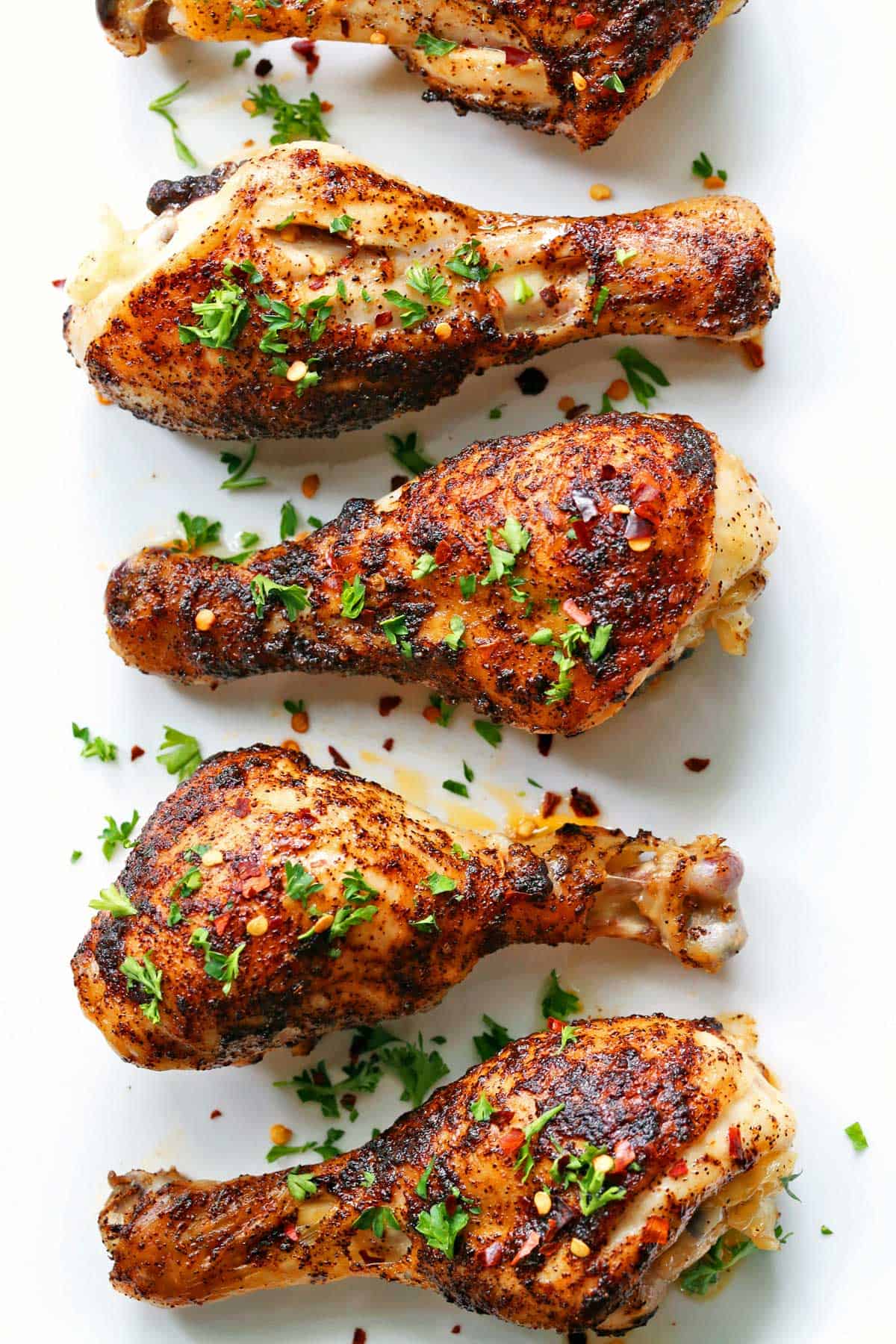 Spicy drumsticks on a white plate. 
