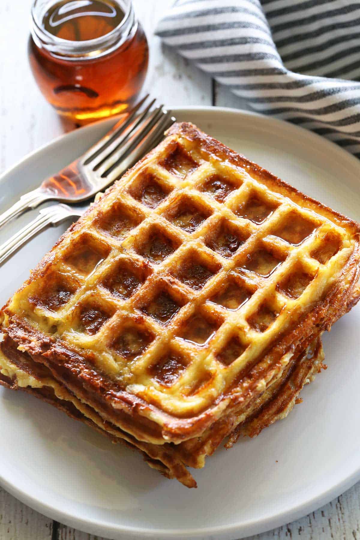 Chaffles served with forks and sugar-free maple syrup. 