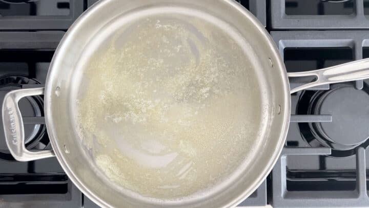 Heating butter in a deep skillet.