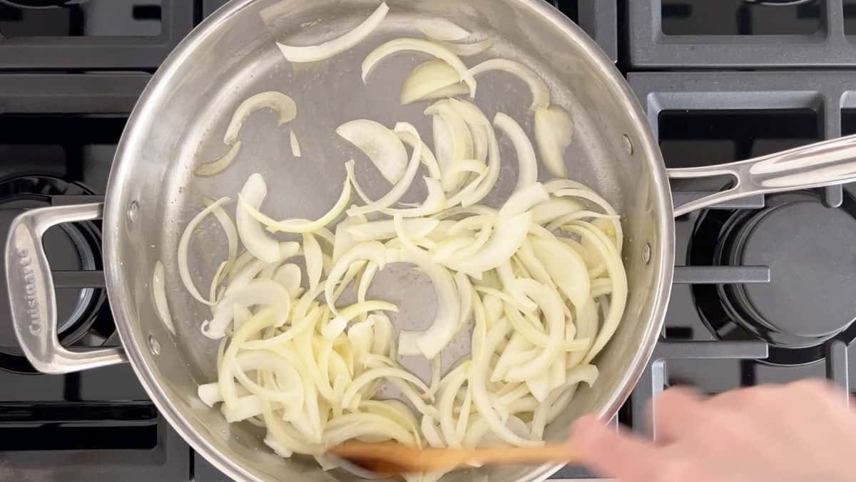 Cooking the onions, stirring often. 