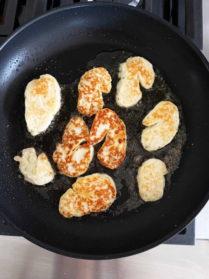 Cooking halloumi in a skillet.