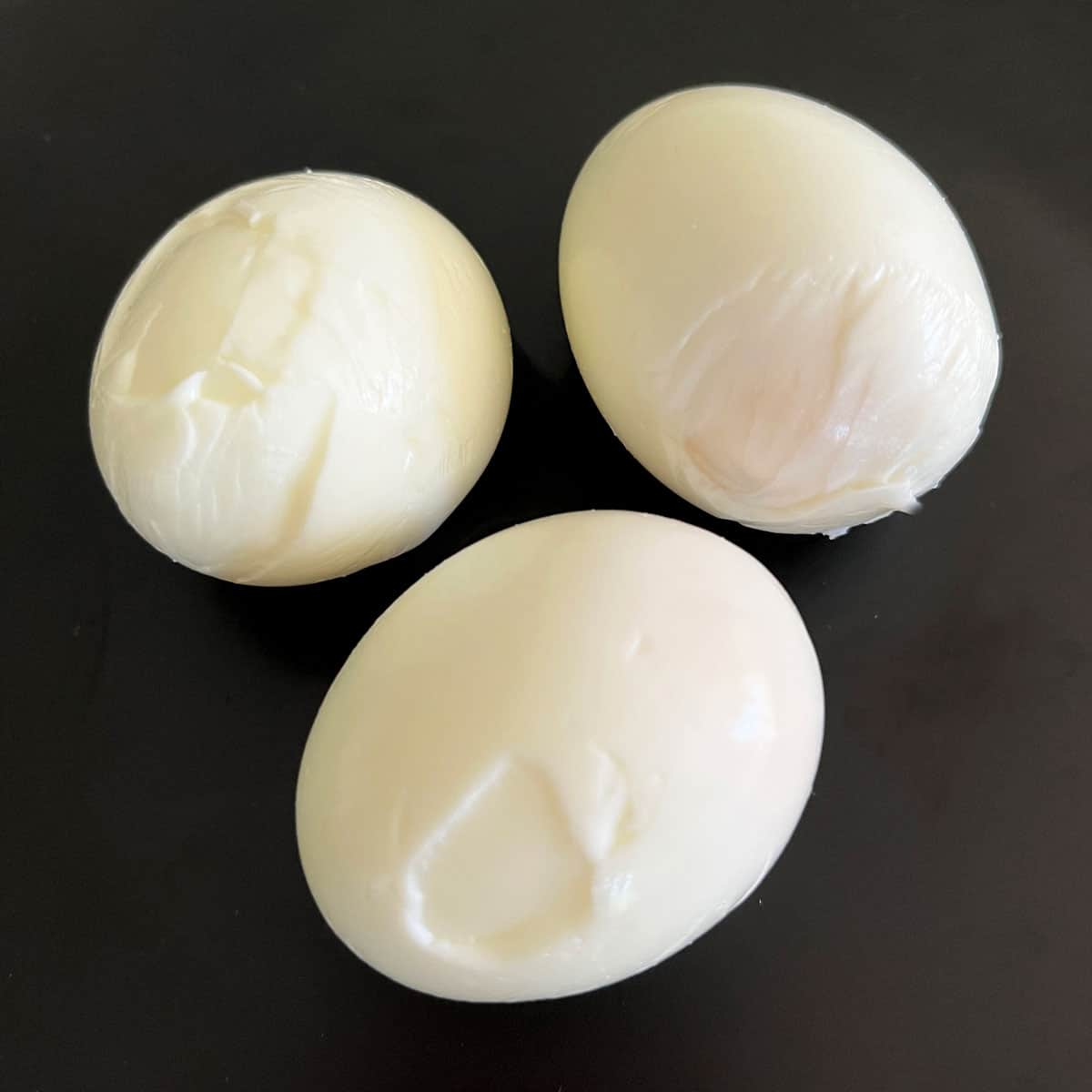 Deformed hard-boiled eggs where the egg white stuck to the inner membrane. 