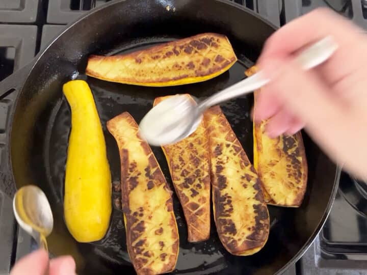 Flipping the squash in the skillet.
