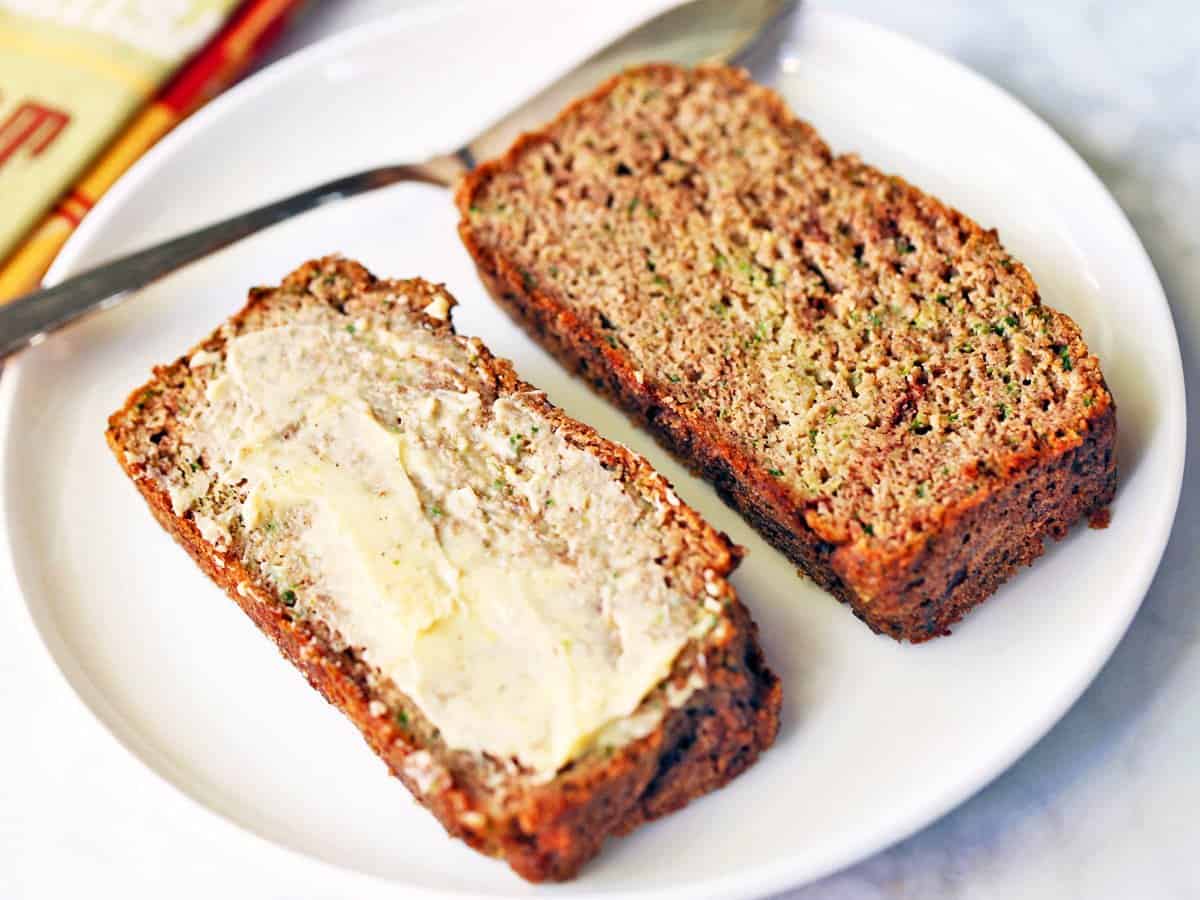 Keto zucchini bread topped with butter. 
