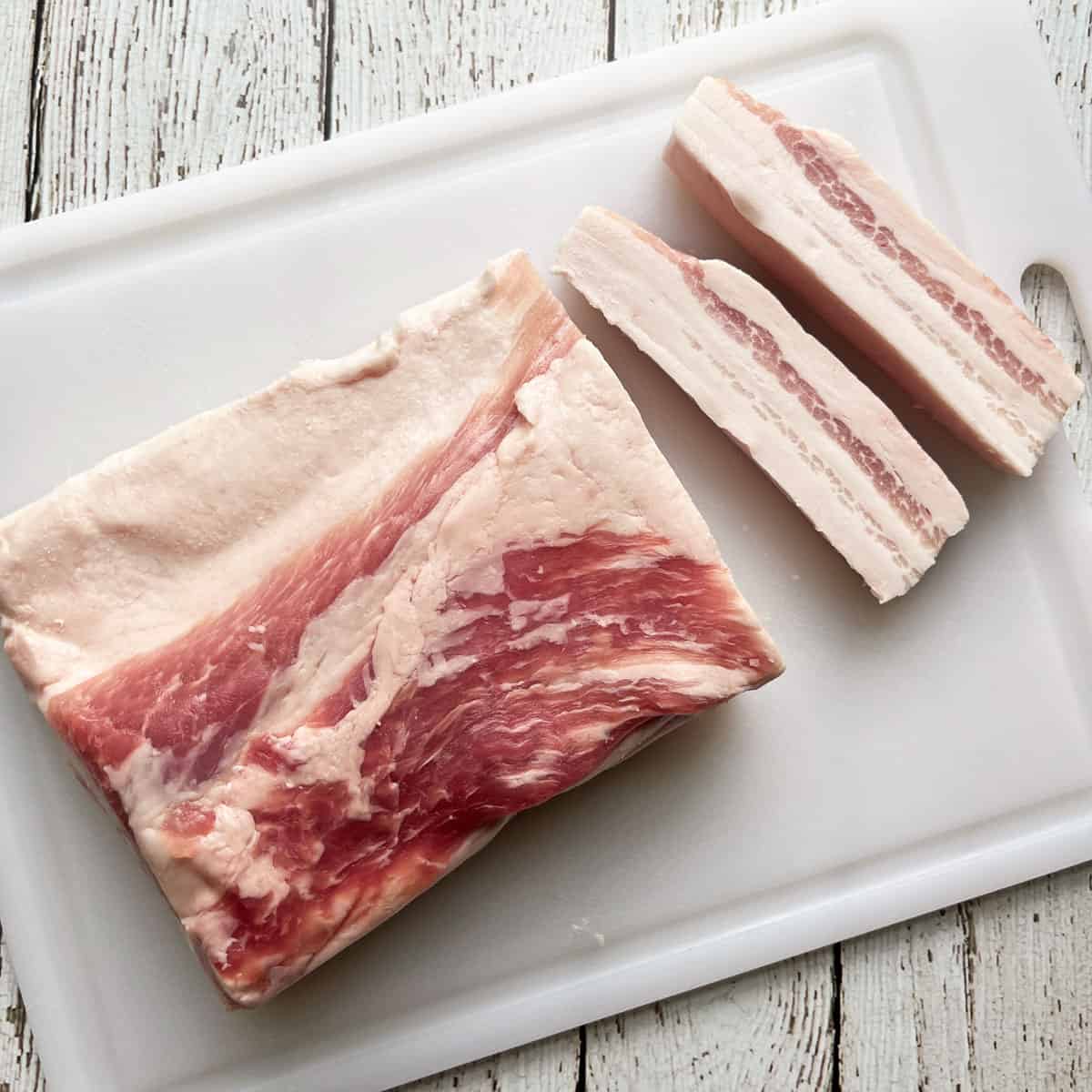 A whole pork belly sliced into strips.