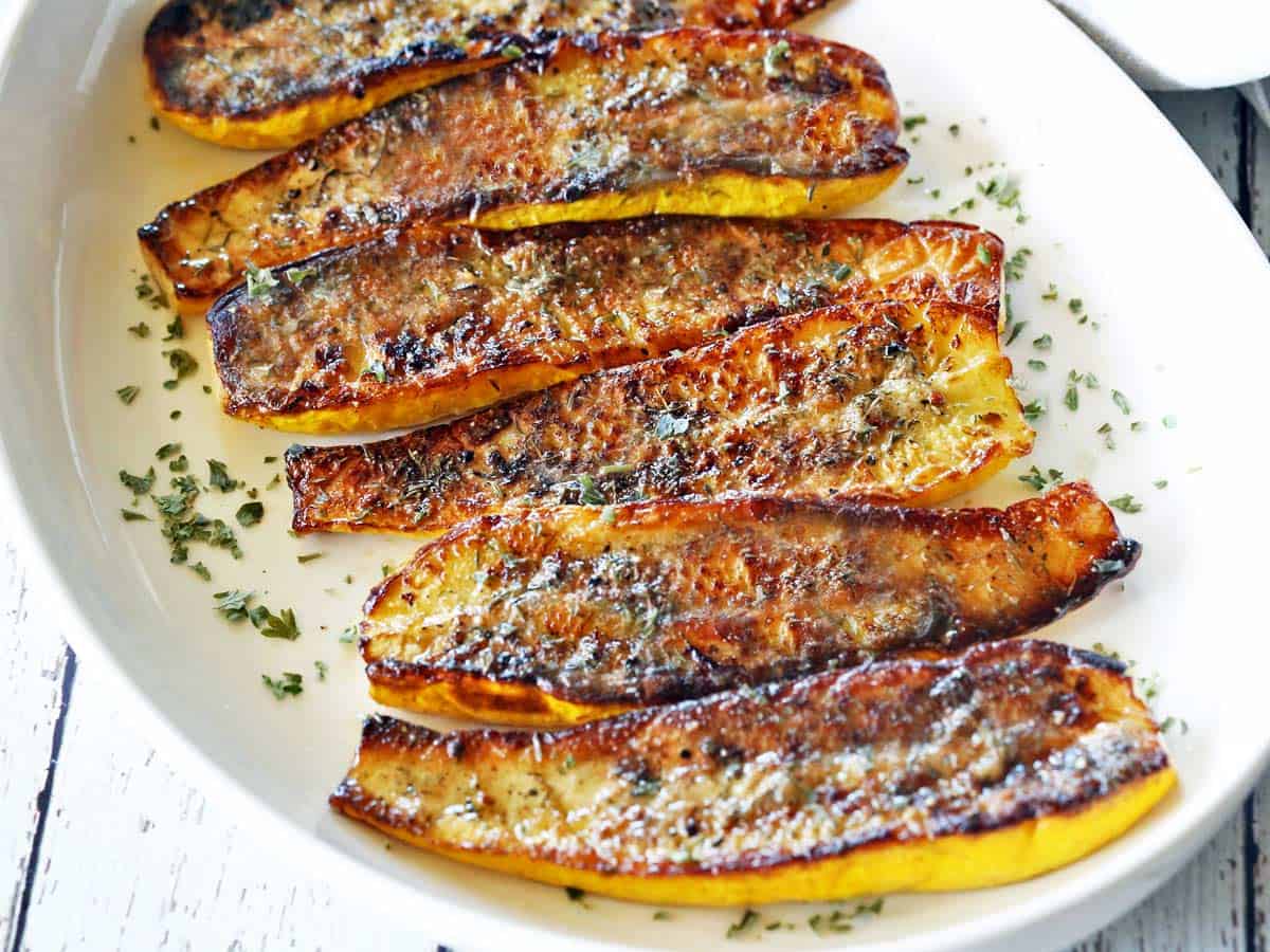 Roasted yellow squash served on a white platter. 