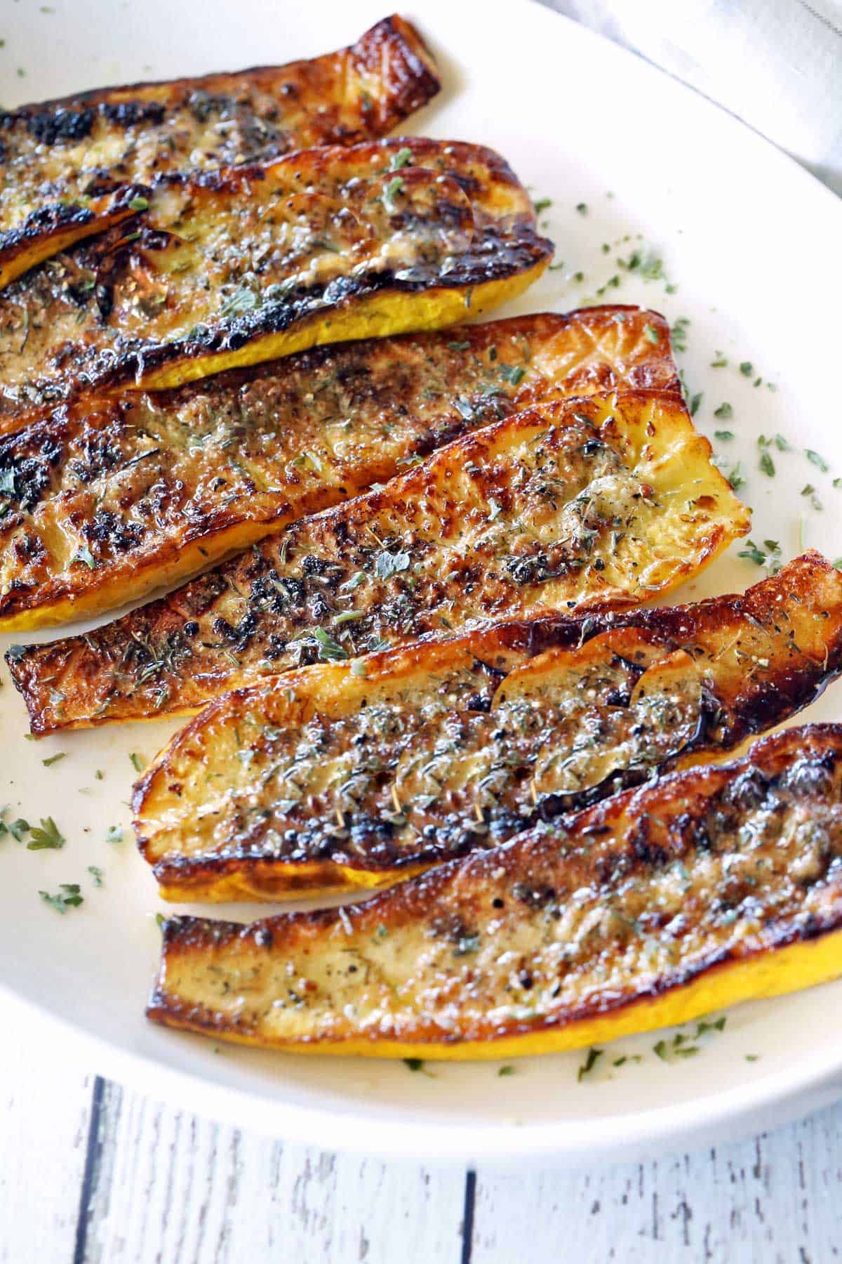 Roasted squash on a white plate. 