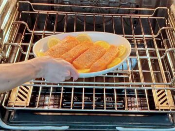 Placing the salmon in the oven.