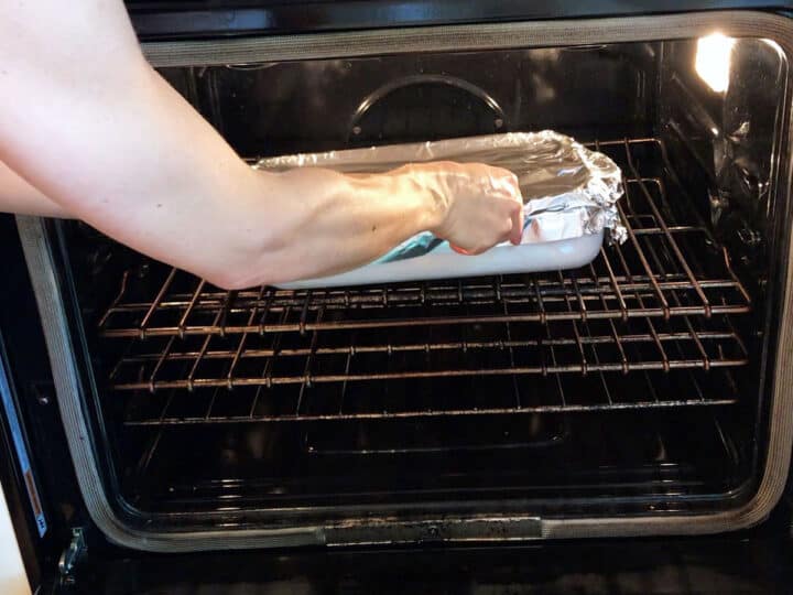 Placing the baking dish in the oven.
