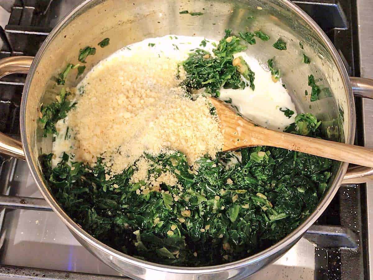 Spinach with cream and parmesan in a saucepan. 