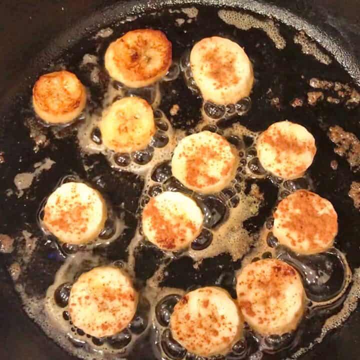 Cooking the banana slices in the skillet.