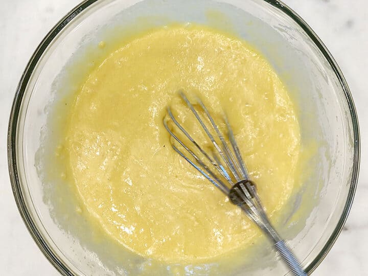 Mixing eggs, melted butter, stevia, and vanilla in a bowl.