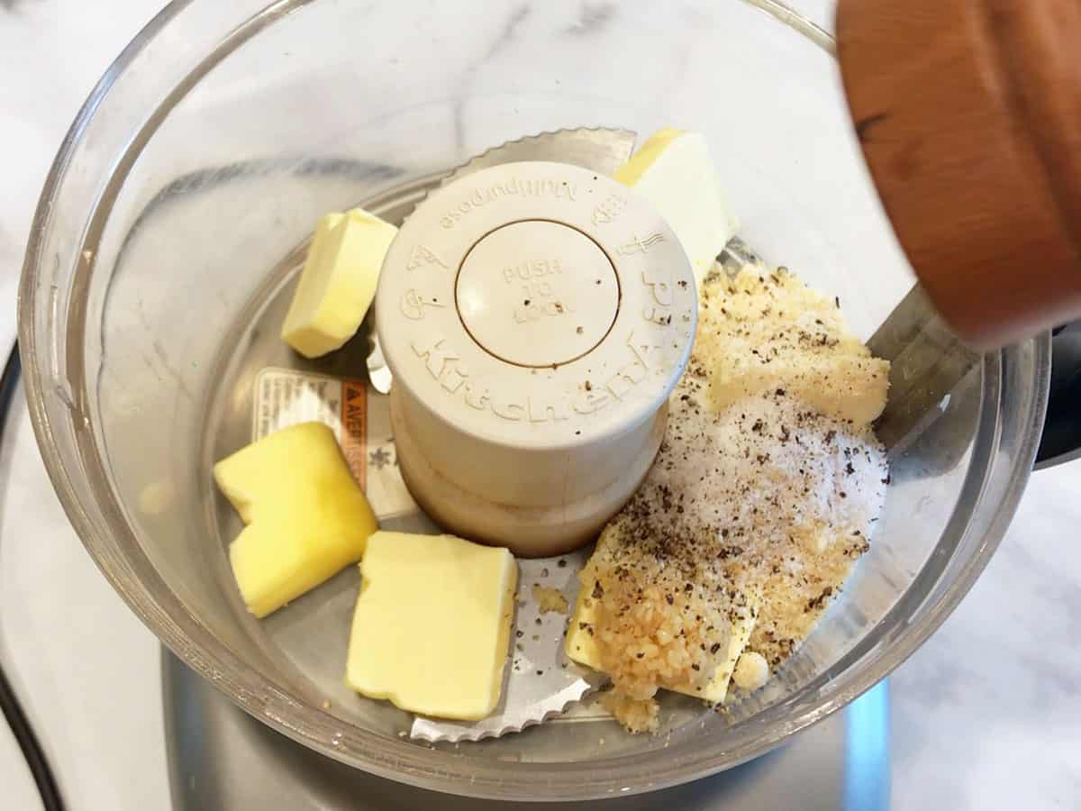 Butter, garlic, parmesan, salt, and pepper in a food processor bowl