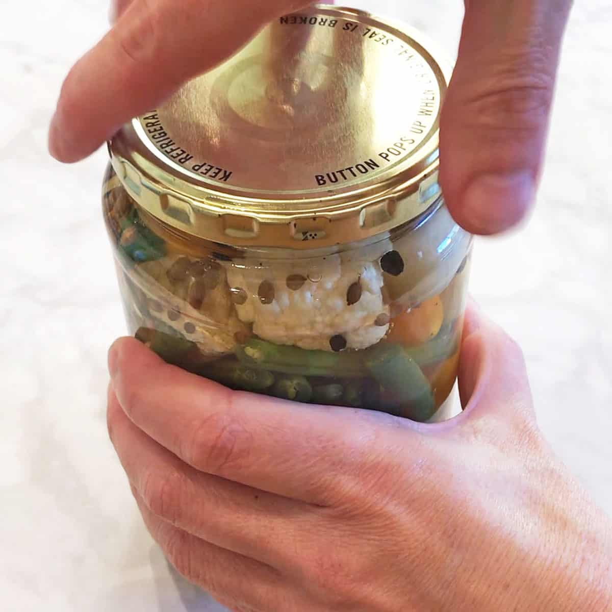 Closing the jar's lid. 