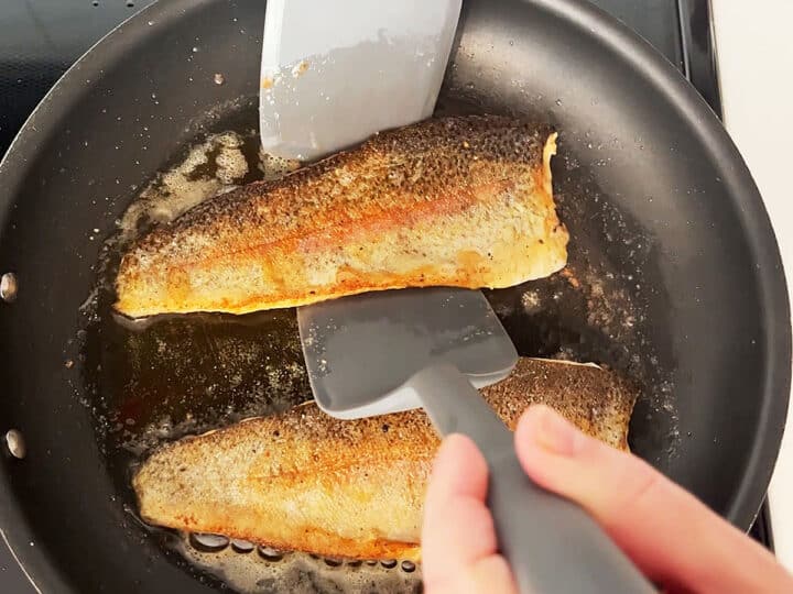 Flipping the trout in the skillet.