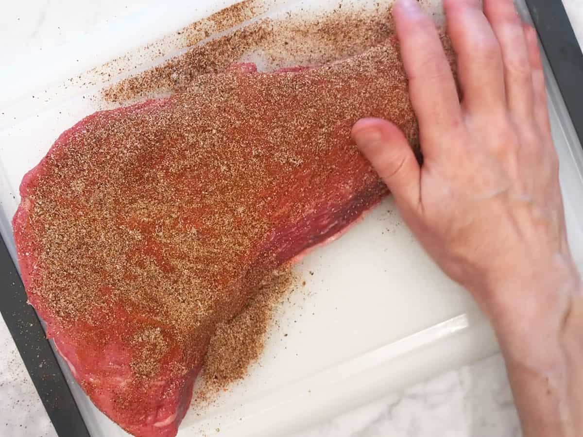 Rubbing tri-tip with spices. 