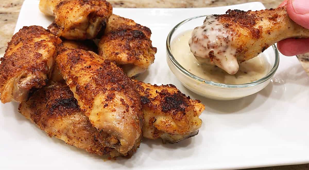 Baked chicken wings served with a dipping sauce. 