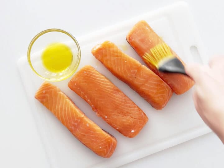 Coating the salmon with olive oil.