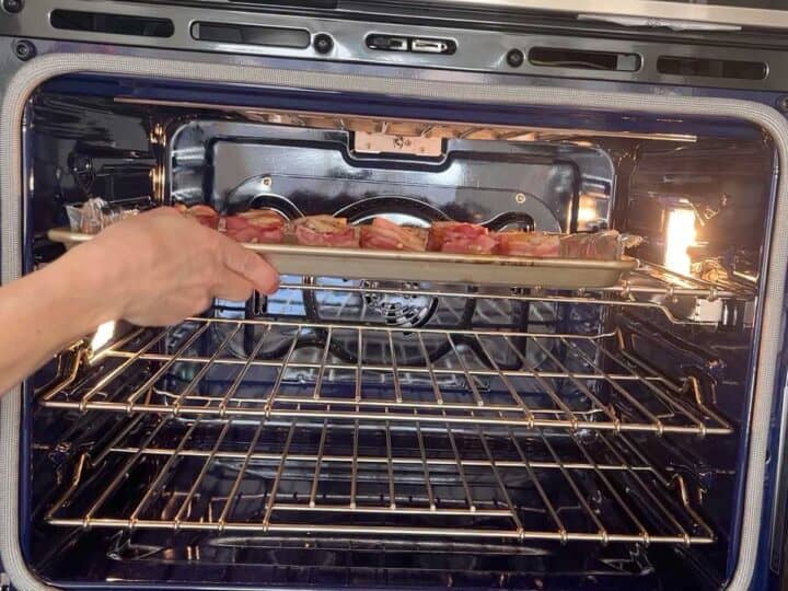 Placing the scallops under the broiler.