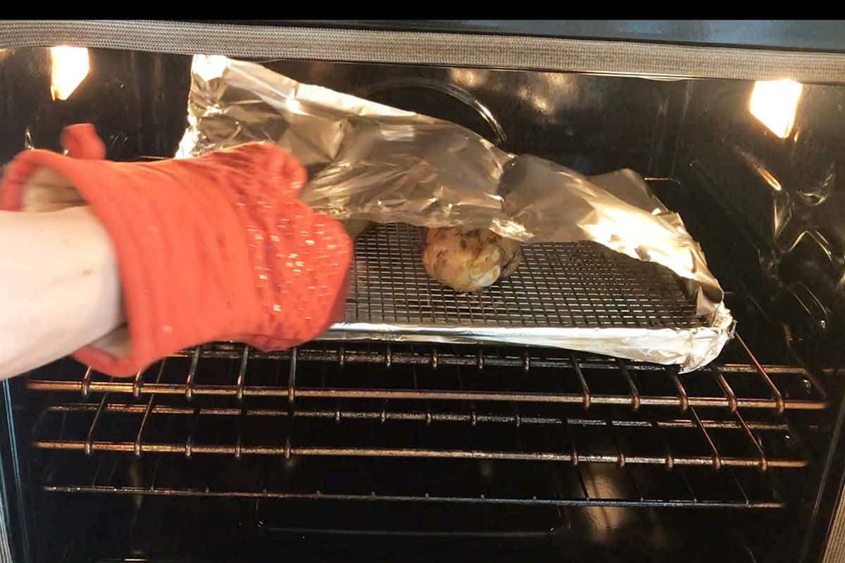 Covering the turkey with foil. 