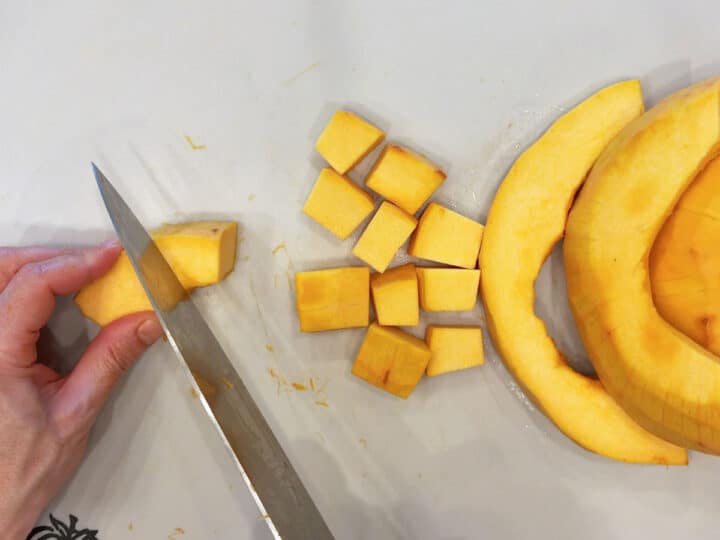 Cutting the pumpkin into cubes.